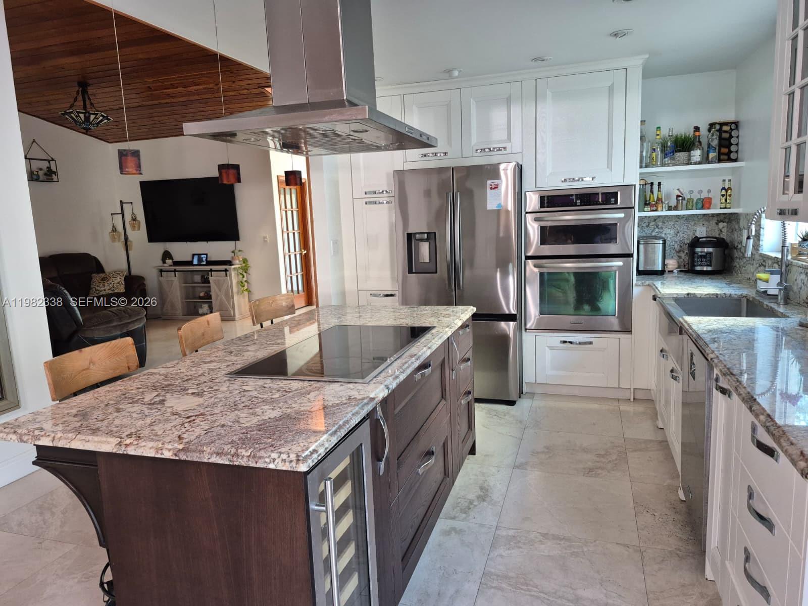14530 Southwest 110th Street Miami, FL 33186 - Photo 10 of 45 a kitchen with stainless steel appliances granite countertop a sink stove and refrigerator