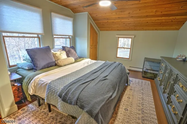 a bed sitting in a bedroom next to a window