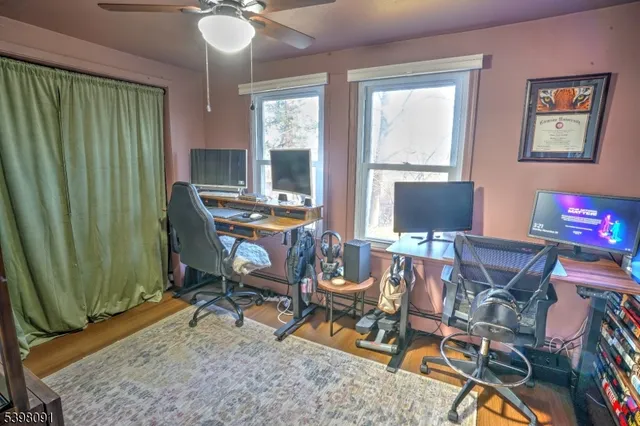a view of a workspace with furniture and a window