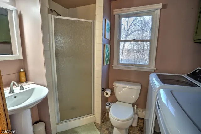 a bathroom with a toilet a sink and a shower