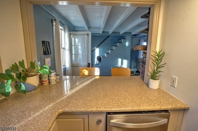a kitchen with a sink and a granite counter top