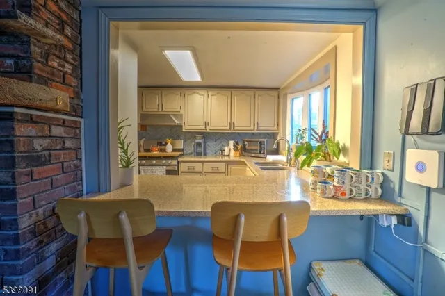 a dining room with furniture a large window and wooden floor