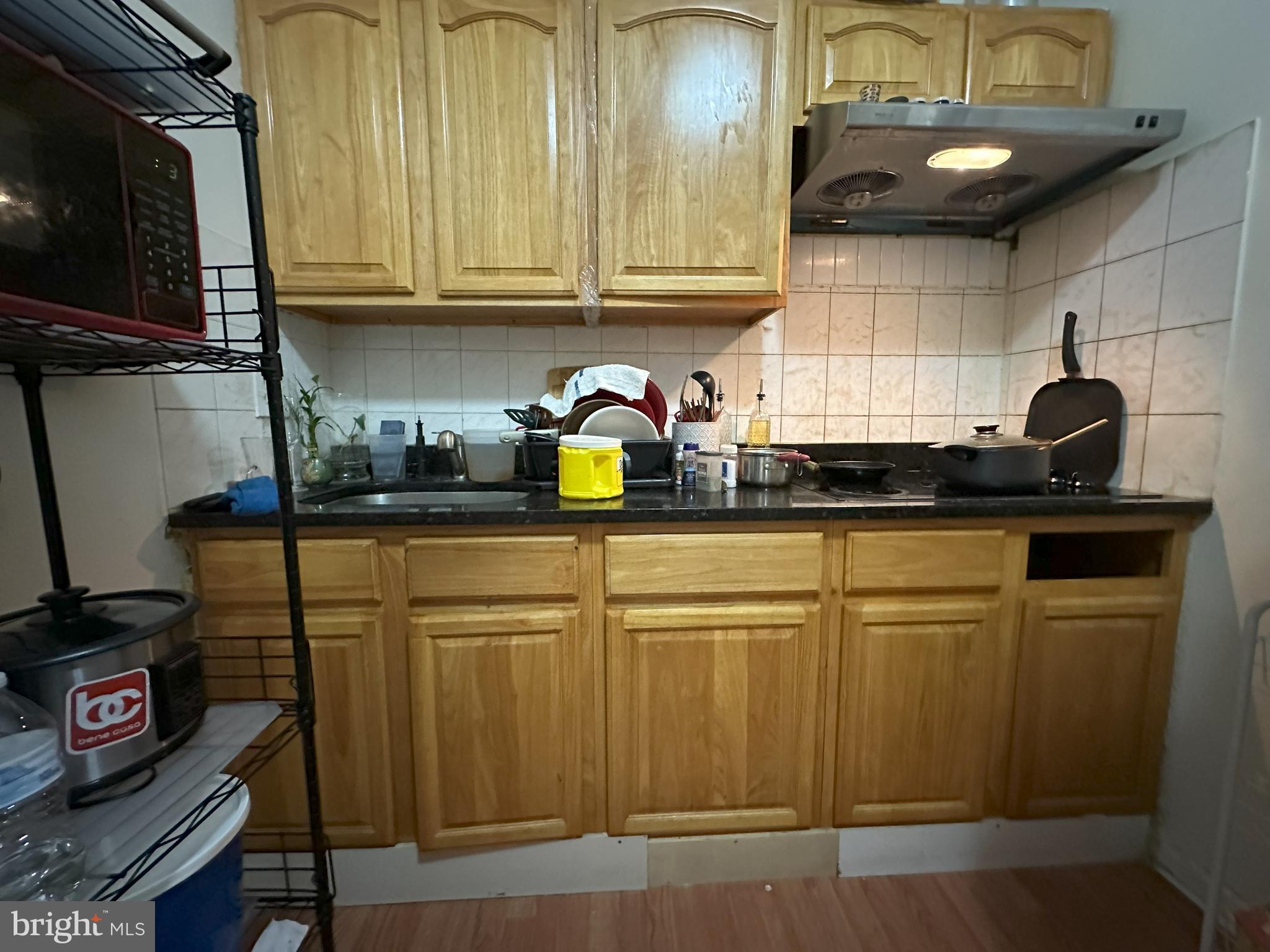2014 South 7th Street Philadelphia, PA 19148 - Photo 13 of 23 a kitchen with granite countertop a sink a stove and cabinets