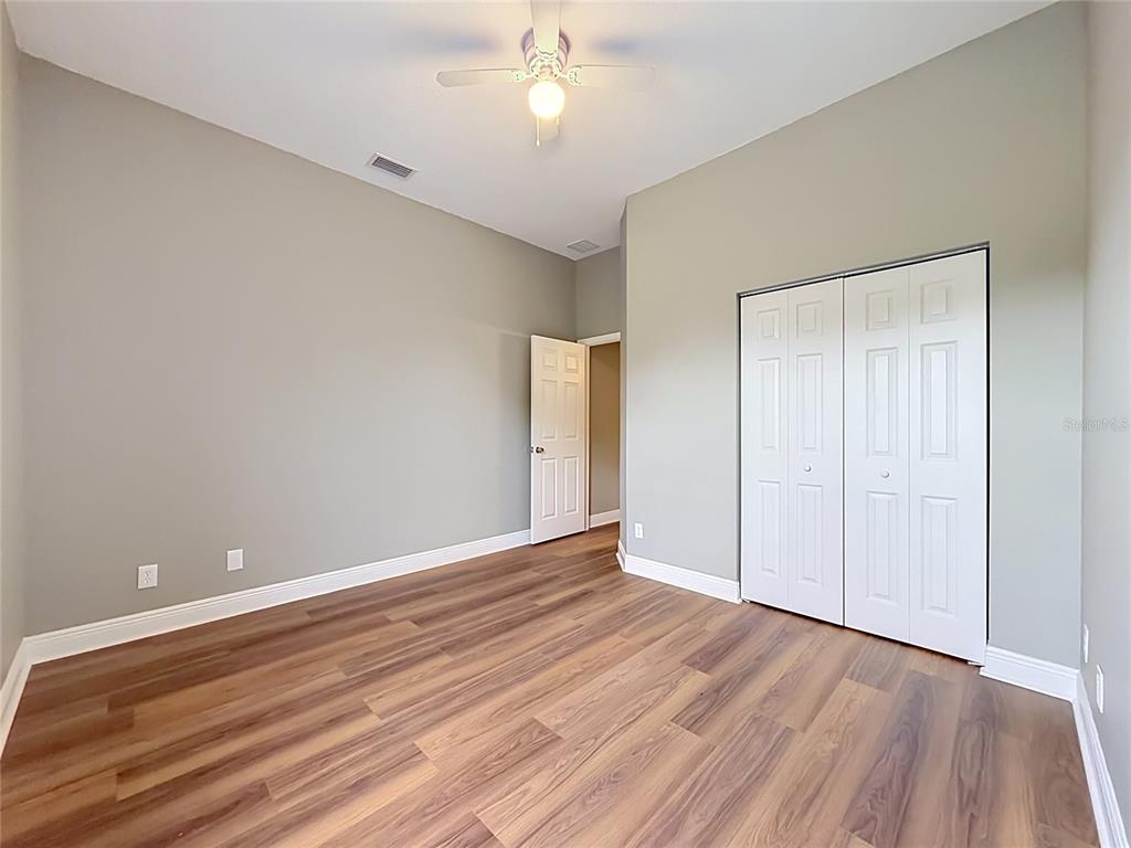 28549 Shirley Shores Road Tavares, FL 32778 - Photo 38 of 65 a view of an empty room with wooden floor
