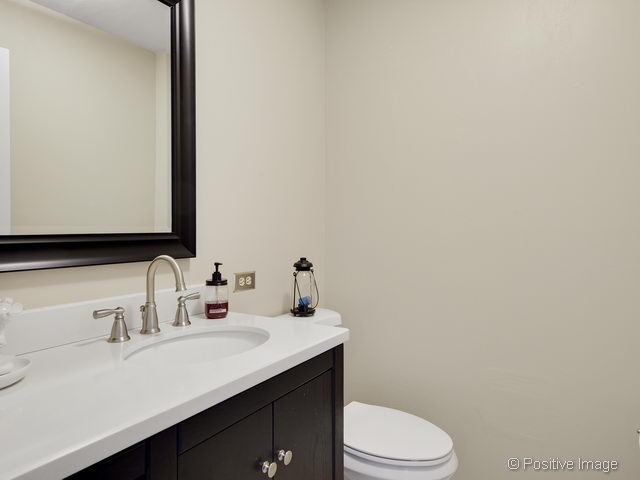 2S184 Sheffield Road Glen Ellyn, IL 60137 - Photo 15 of 25 a bathroom with a sink a toilet and mirror