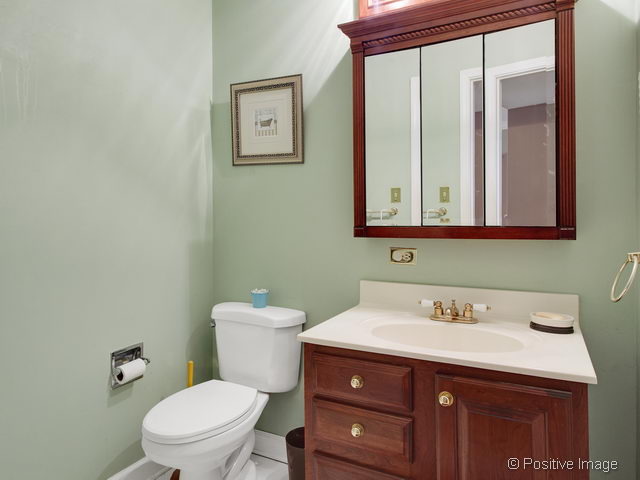 2S184 Sheffield Road Glen Ellyn, IL 60137 - Photo 17 of 25 a bathroom with a toilet sink and mirror