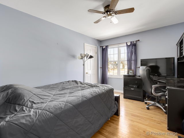 2S184 Sheffield Road Glen Ellyn, IL 60137 - Photo 18 of 25 a bedroom with a bed and a flat screen tv