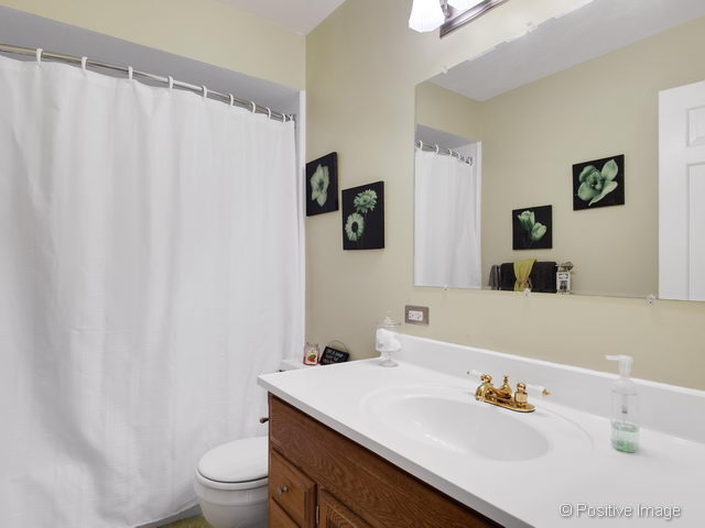 2S184 Sheffield Road Glen Ellyn, IL 60137 - Photo 21 of 25 a bathroom with a sink a toilet and a mirror