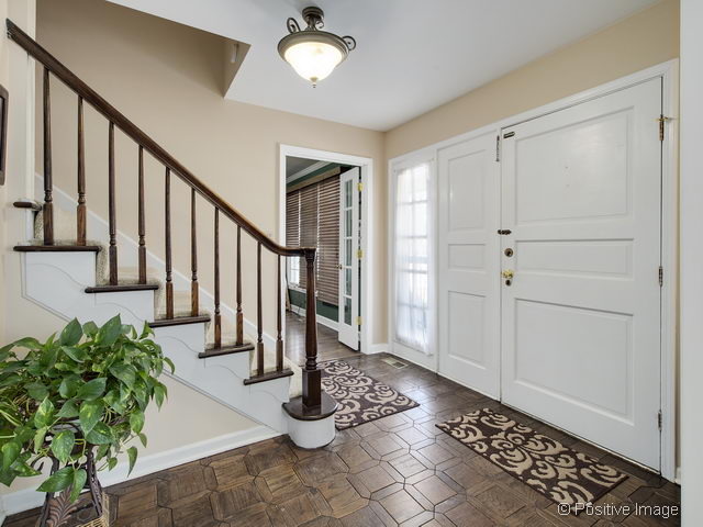 2S184 Sheffield Road Glen Ellyn, IL 60137 - Photo 4 of 25 a view of entryway with wooden floor and a rug