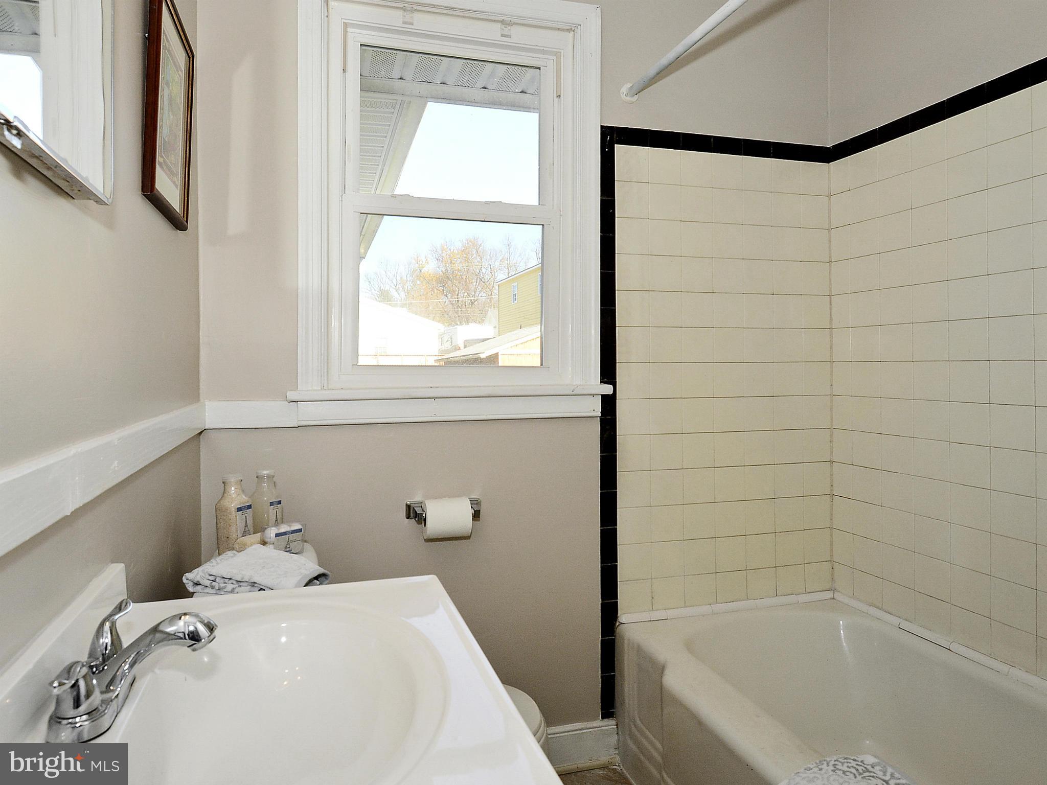2721 Randolph Road Silver Spring, MD 20902 - Photo 12 of 25 a bathroom with a sink a bathtub and window