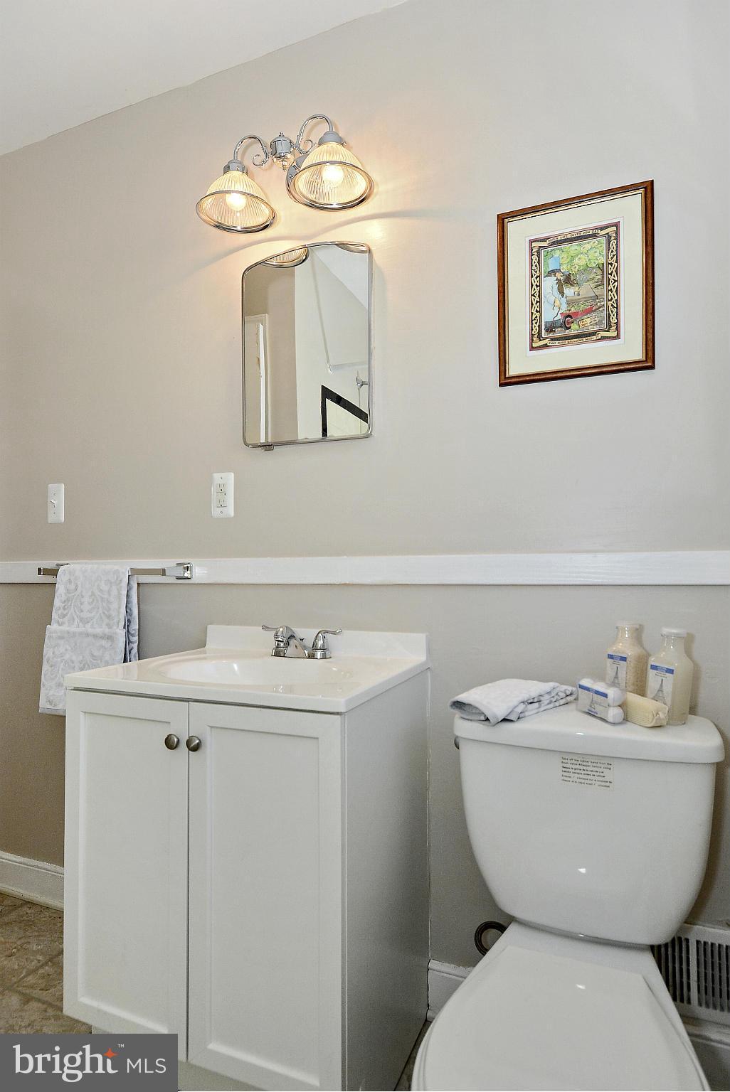 2721 Randolph Road Silver Spring, MD 20902 - Photo 13 of 25 a bathroom with a toilet sink and mirror