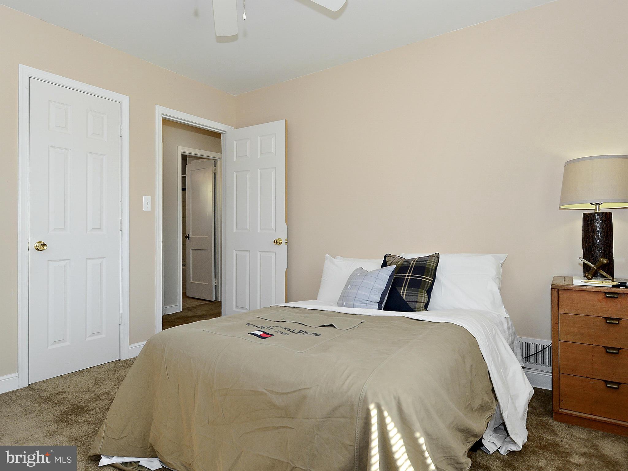 2721 Randolph Road Silver Spring, MD 20902 - Photo 16 of 25 a bedroom with a bed and a lamp