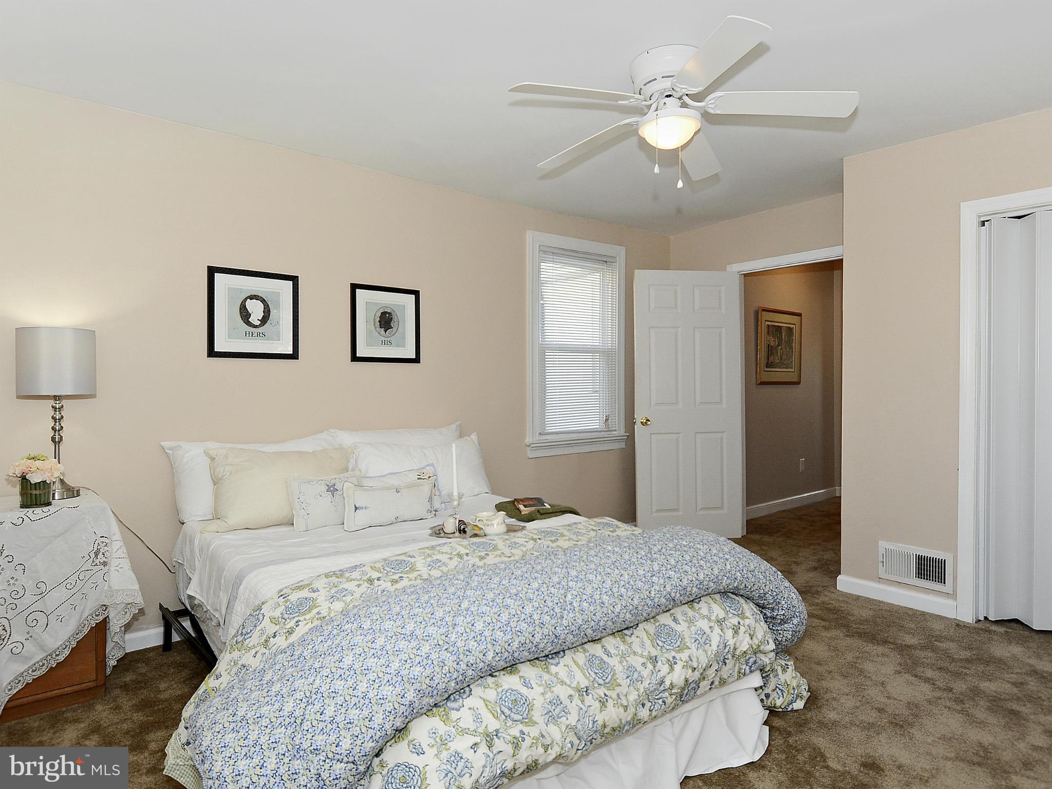 2721 Randolph Road Silver Spring, MD 20902 - Photo 10 of 25 a bedroom with a large bed and a chandelier