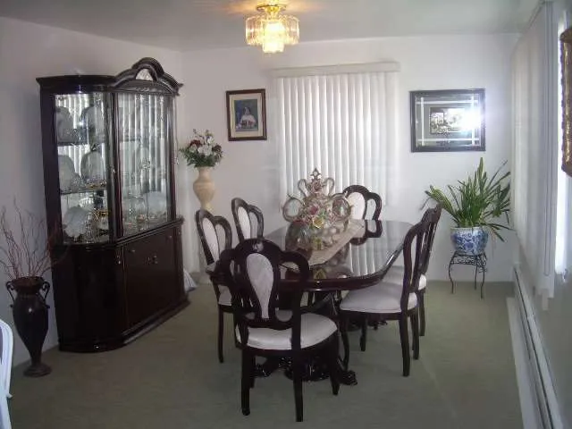 a dining room with furniture and window