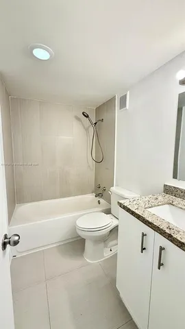 a utility room with a sink a toilet and mirror