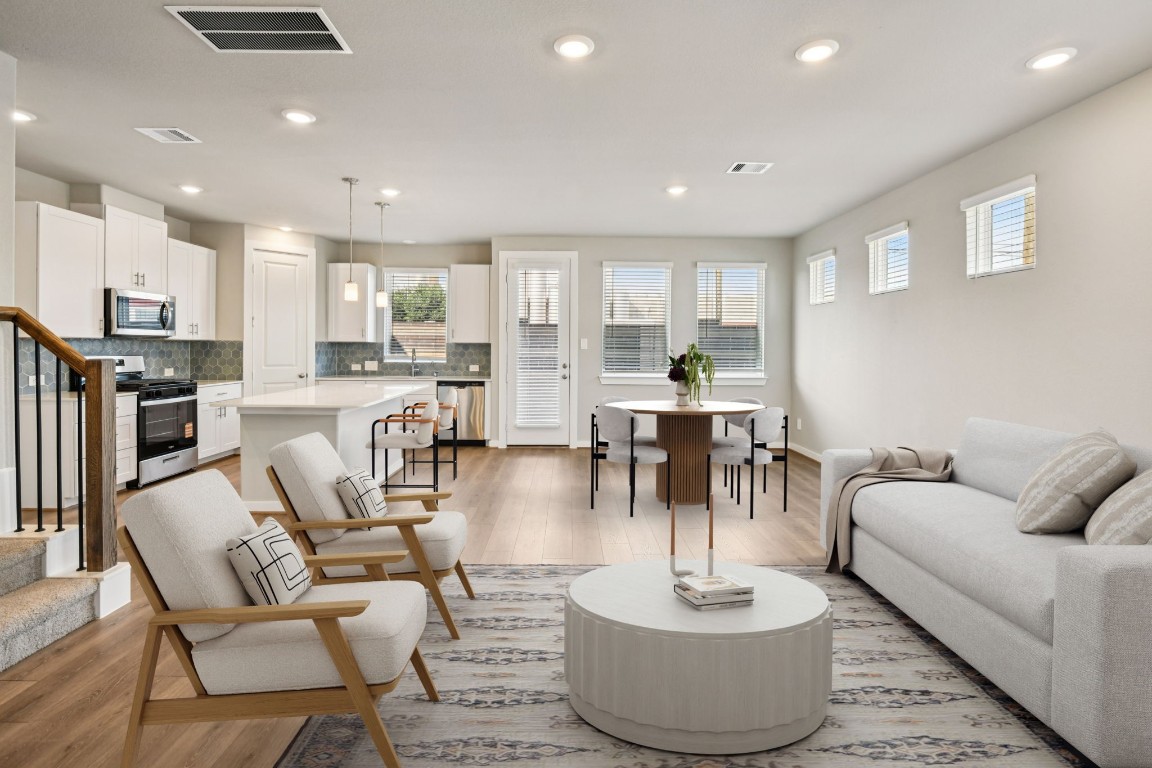 a living room with fireplace furniture and a wooden floor