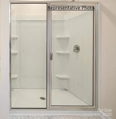 a bathroom with a glass shower door