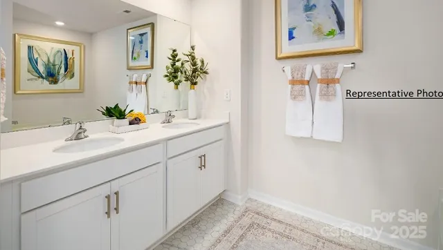 a bathroom with a sink mirror and vanity