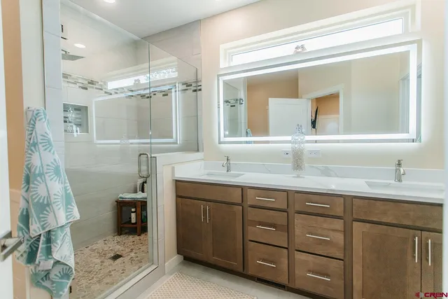 a bathroom with a granite countertop sink mirror and double