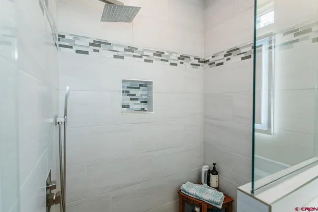 a bathroom with a shower and cabinets