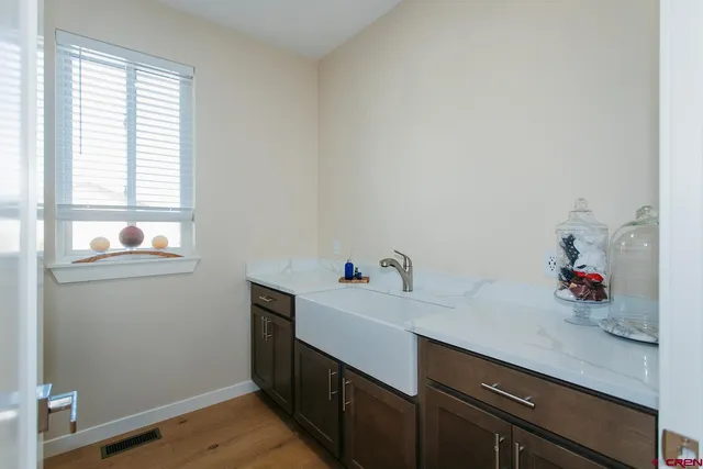 a view of a room with a window and wooden floor