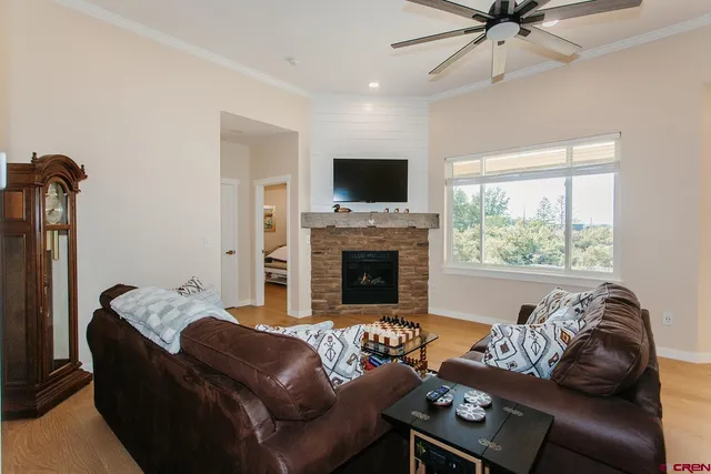 a living room with furniture a flat screen tv and a fireplace