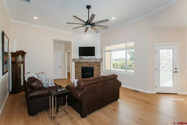 a living room with furniture fireplace and a window