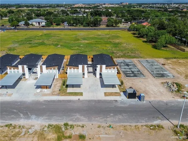 an aerial view of residential houses with outdoor space
