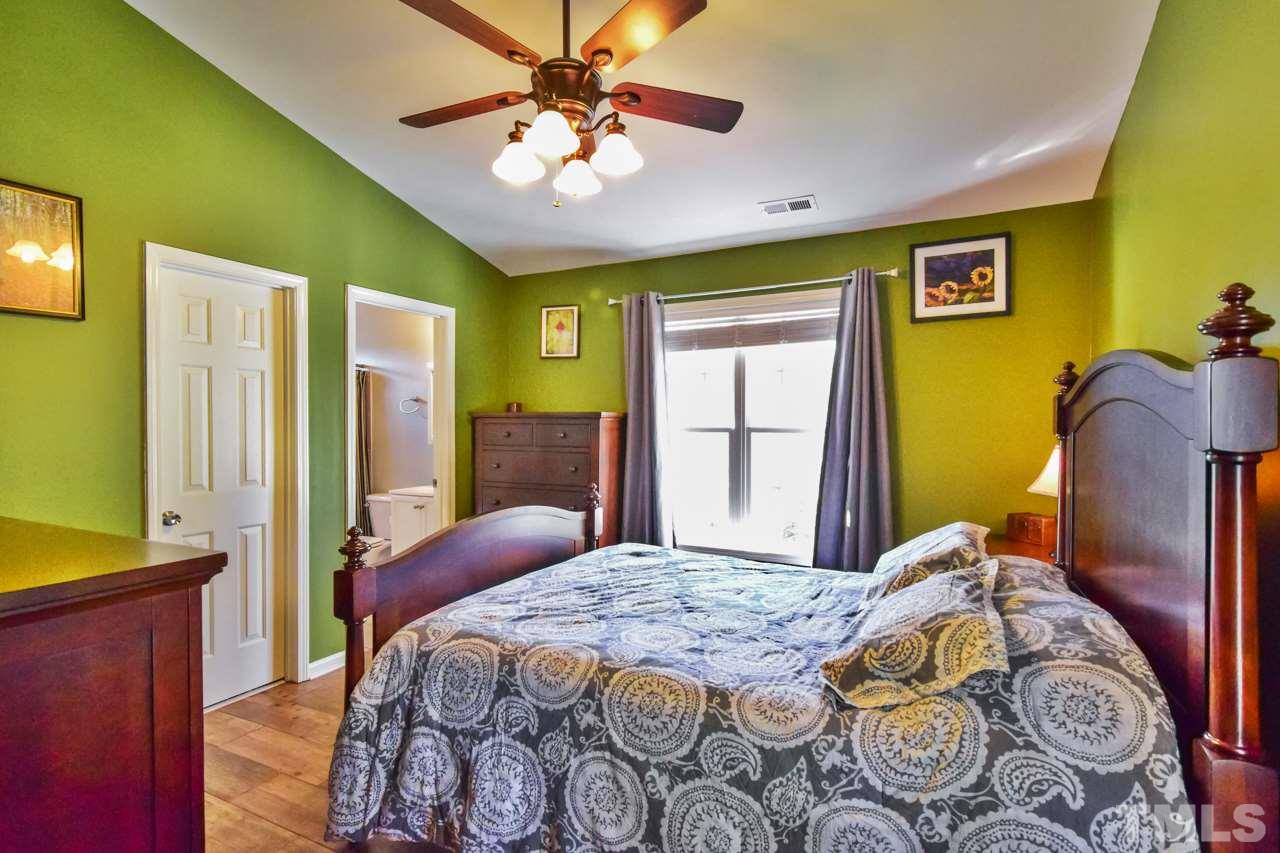 702 Method Road Raleigh, NC 27607 - Photo 14 of 25 a bedroom with a bed and a chandelier