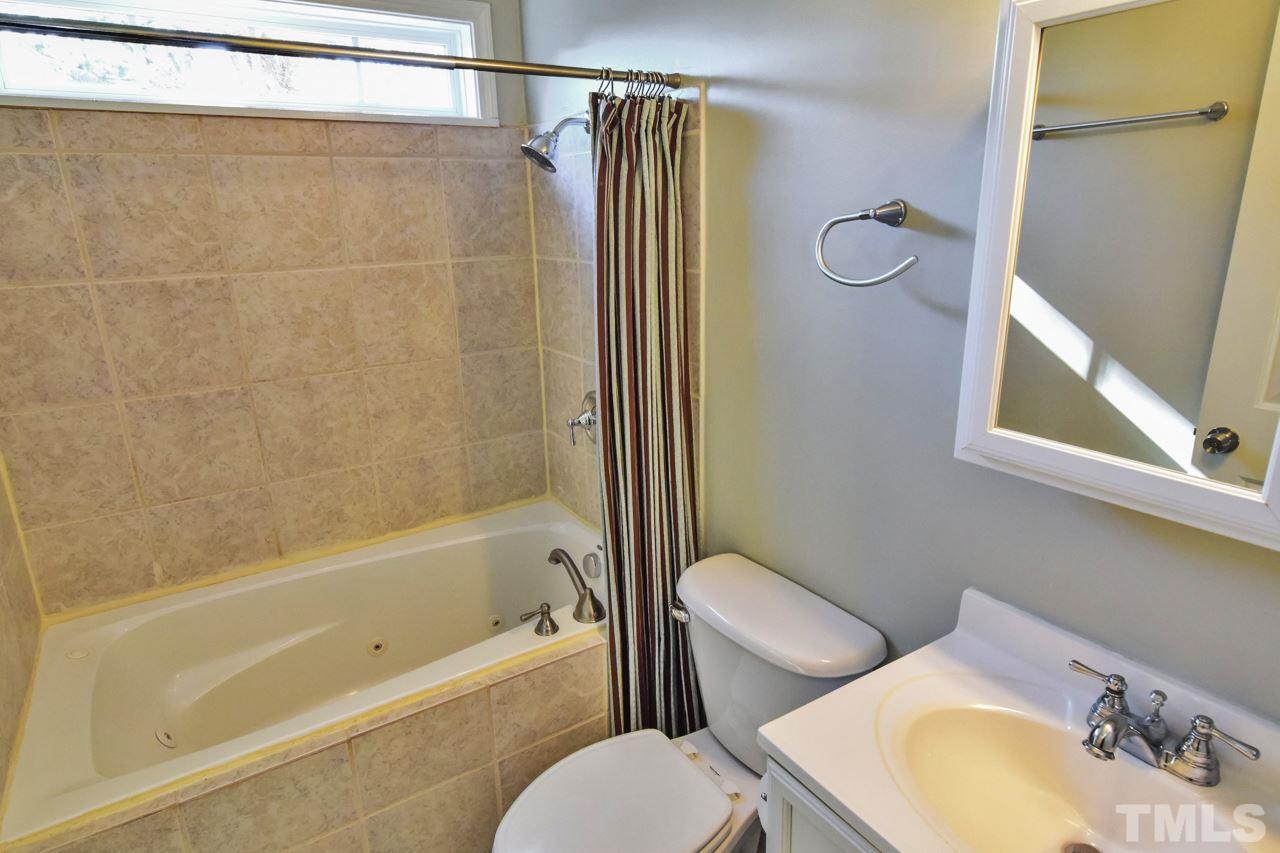 702 Method Road Raleigh, NC 27607 - Photo 16 of 25 a bathroom with a sink toilet and shower
