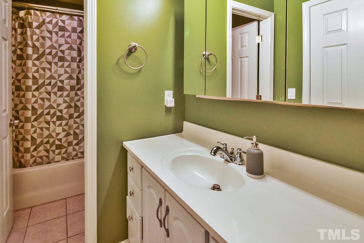 702 Method Road Raleigh, NC 27607 - Photo 18 of 25 a bathroom with a sink and mirror