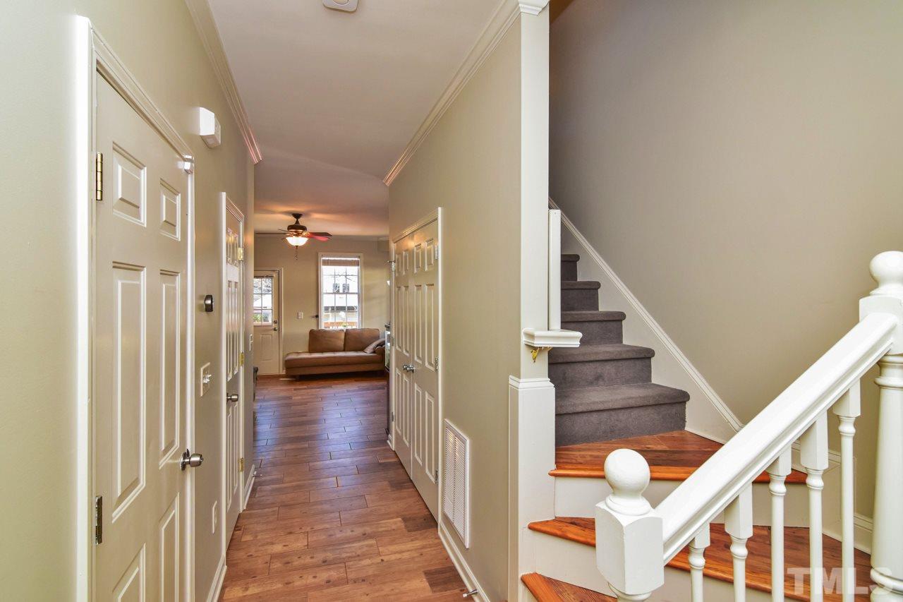 702 Method Road Raleigh, NC 27607 - Photo 3 of 25 a view of a hallway with wooden floor and staircase