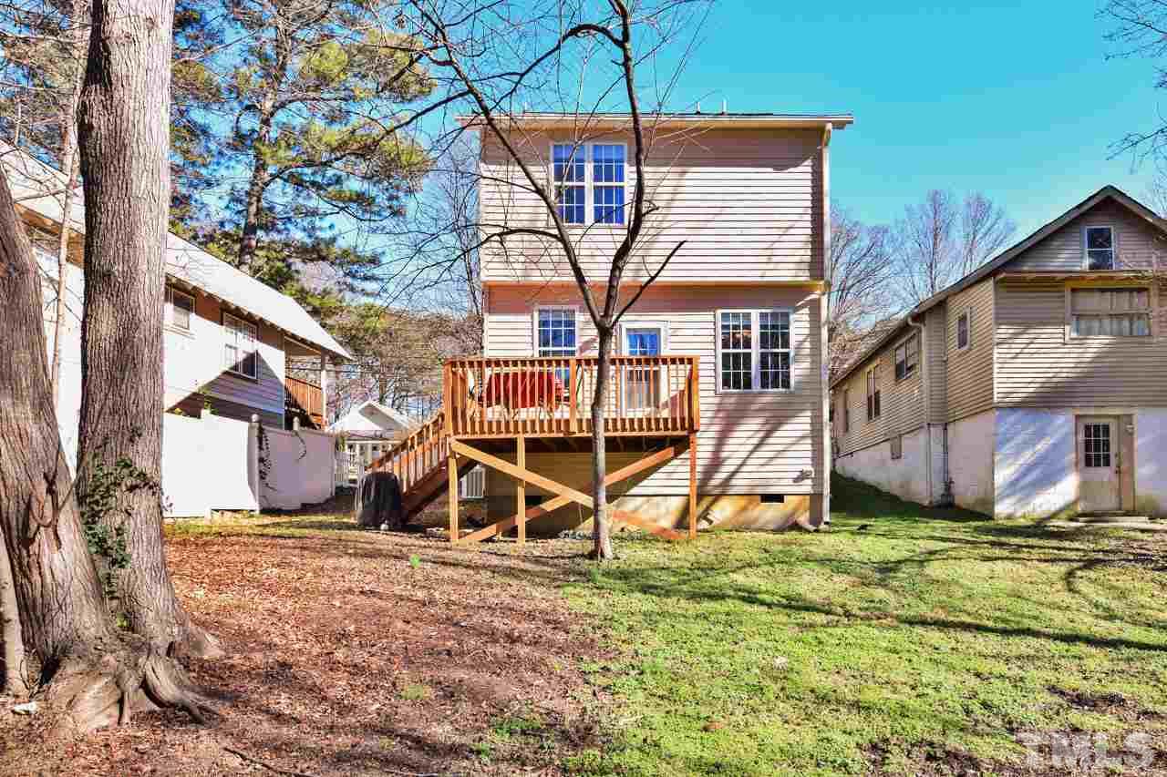 702 Method Road Raleigh, NC 27607 - Photo 23 of 25 a view of a house with backyard and wooden fence