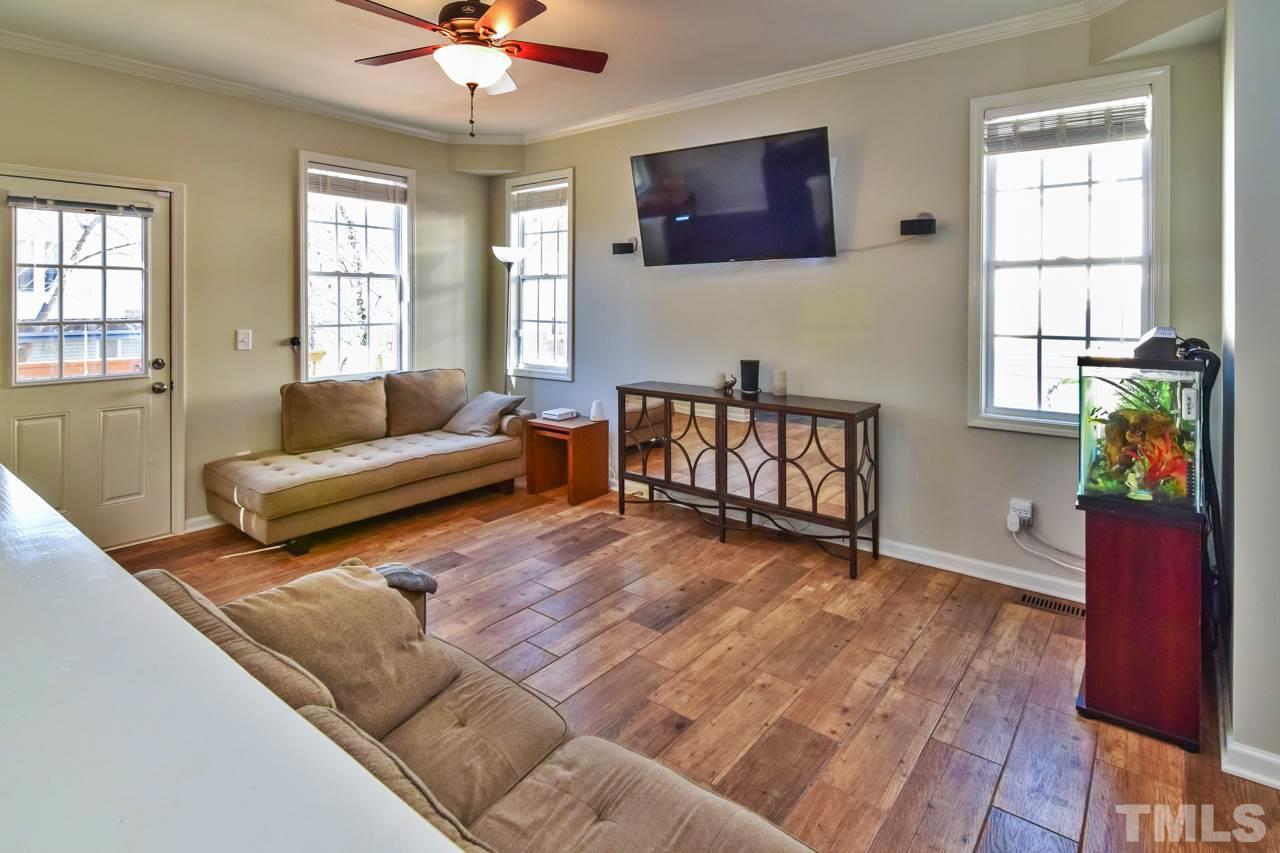 702 Method Road Raleigh, NC 27607 - Photo 5 of 25 a living room with furniture and a wooden floor