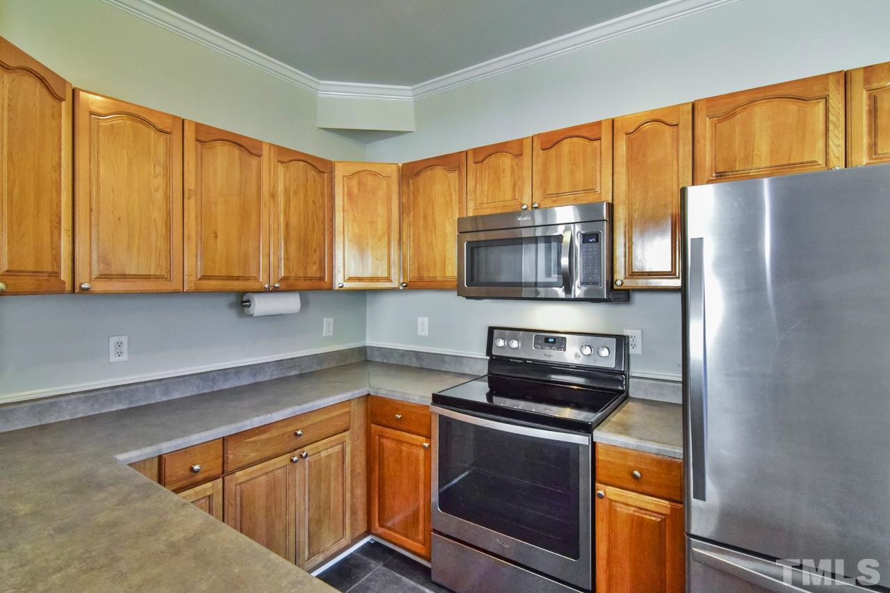 702 Method Road Raleigh, NC 27607 - Photo 7 of 25 a kitchen with stainless steel appliances granite countertop a refrigerator stove and microwave