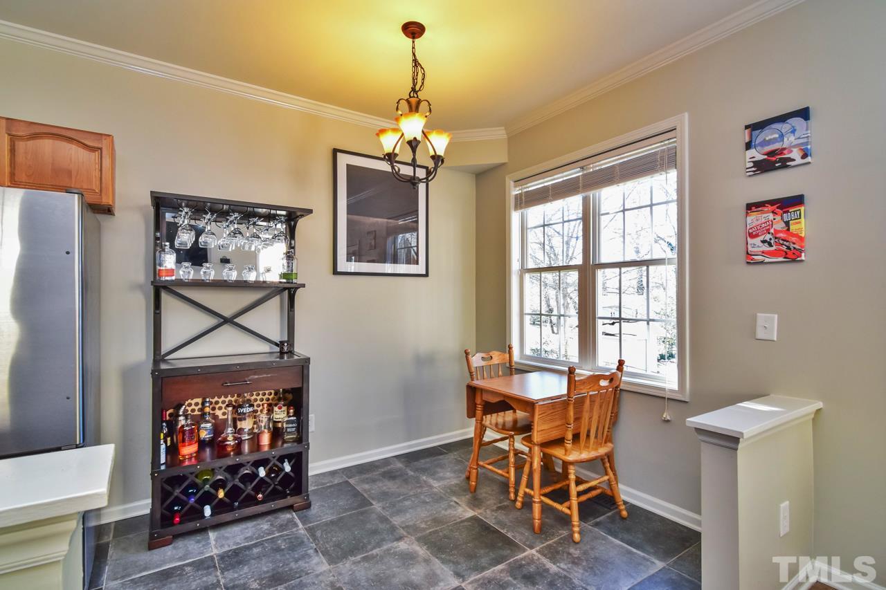 702 Method Road Raleigh, NC 27607 - Photo 9 of 25 a view of a dining room with furniture window and wooden floor