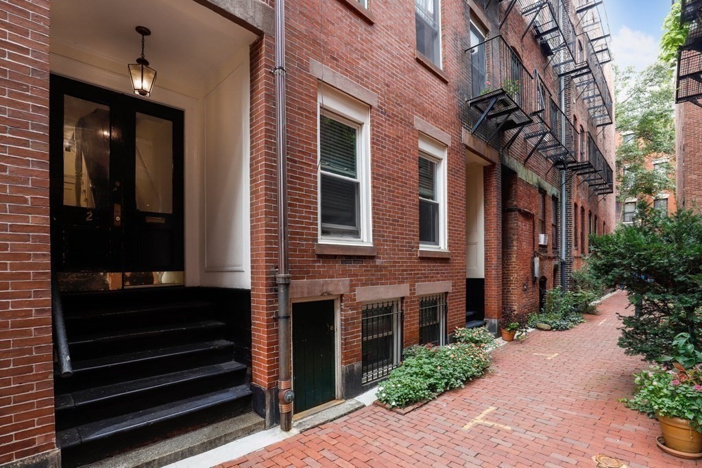 a view of a brick house with many windows