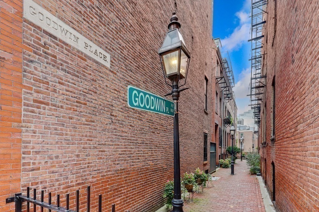 2 Goodwin Place, Unit 3 Boston, MA 02114 - Photo 17 of 28 a brick building with a street sign on it