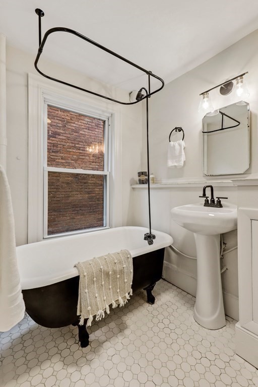 2 Goodwin Place, Unit 3 Boston, MA 02114 - Photo 18 of 28 a bathroom with a sink and a mirror