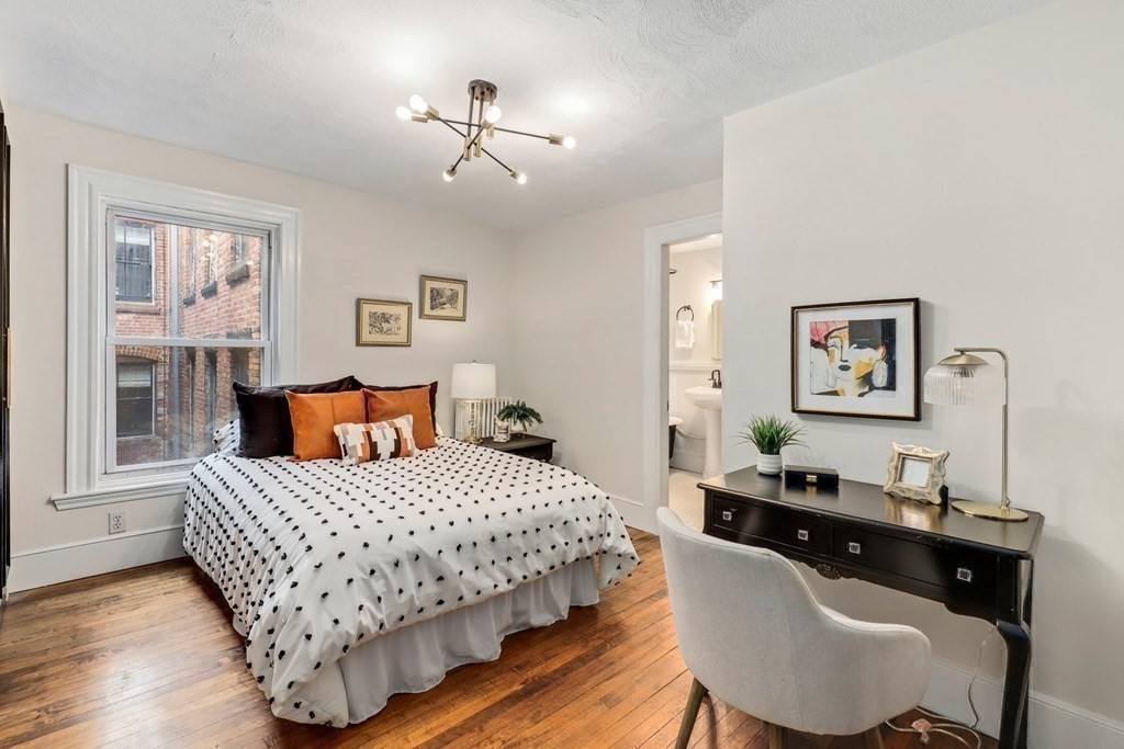 2 Goodwin Place, Unit 3 Boston, MA 02114 - Photo 19 of 28 a bedroom with a bed and wooden floor