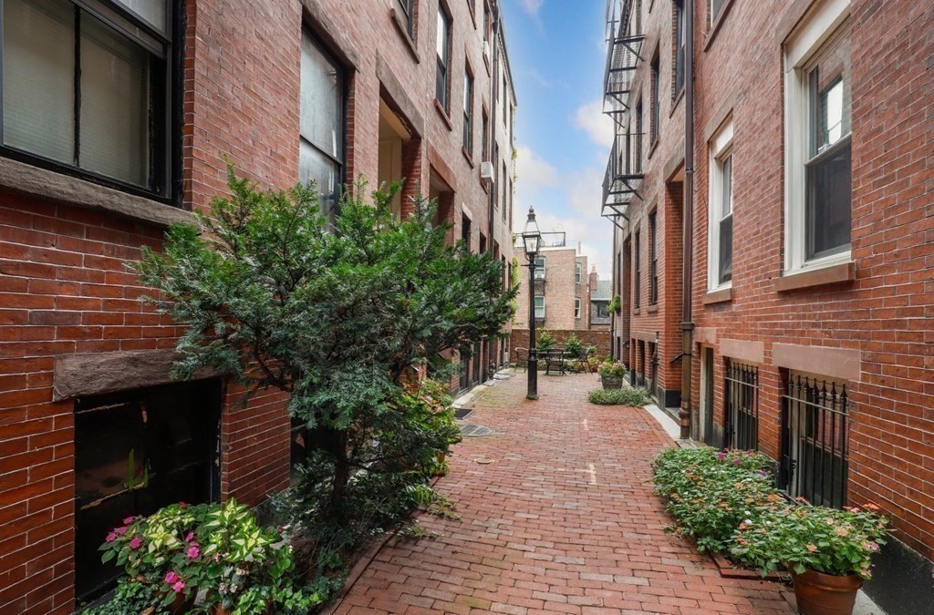 2 Goodwin Place, Unit 3 Boston, MA 02114 - Photo 2 of 28 a pathway of a house with a yard