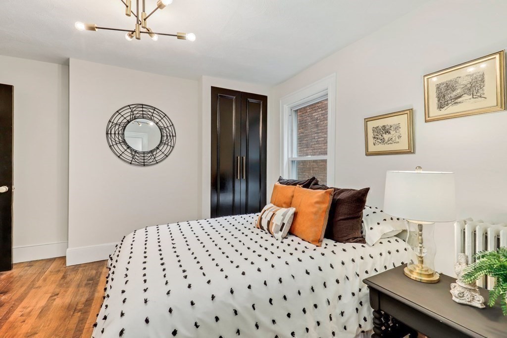 2 Goodwin Place, Unit 3 Boston, MA 02114 - Photo 21 of 28 a bedroom with a bed and a table in it