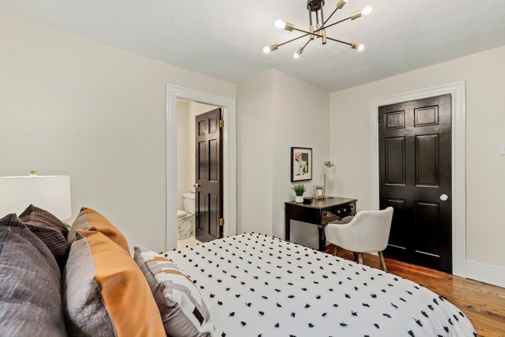 2 Goodwin Place, Unit 3 Boston, MA 02114 - Photo 22 of 28 a bedroom with a bed and wooden floor