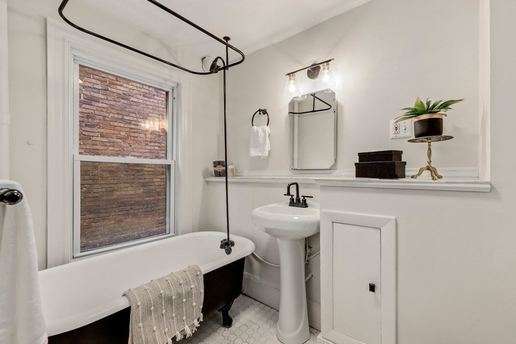 2 Goodwin Place, Unit 3 Boston, MA 02114 - Photo 23 of 28 a bathroom with a sink and a mirror