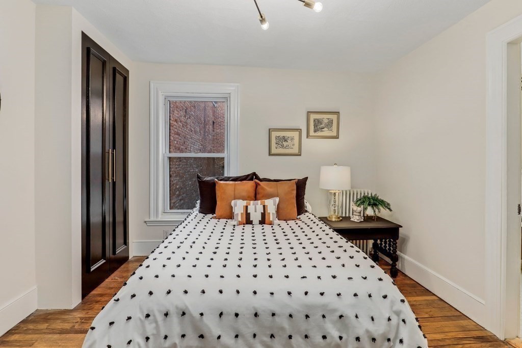 2 Goodwin Place, Unit 3 Boston, MA 02114 - Photo 24 of 28 a bedroom with a bed and wooden floor