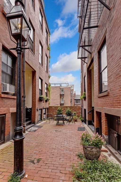 2 Goodwin Place, Unit 3 Boston, MA 02114 - Photo 26 of 28 a view of a patio with table and chairs potted plants