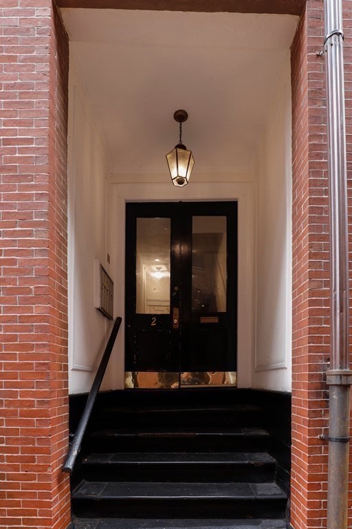 2 Goodwin Place, Unit 3 Boston, MA 02114 - Photo 27 of 28 a front view of a house with stairs