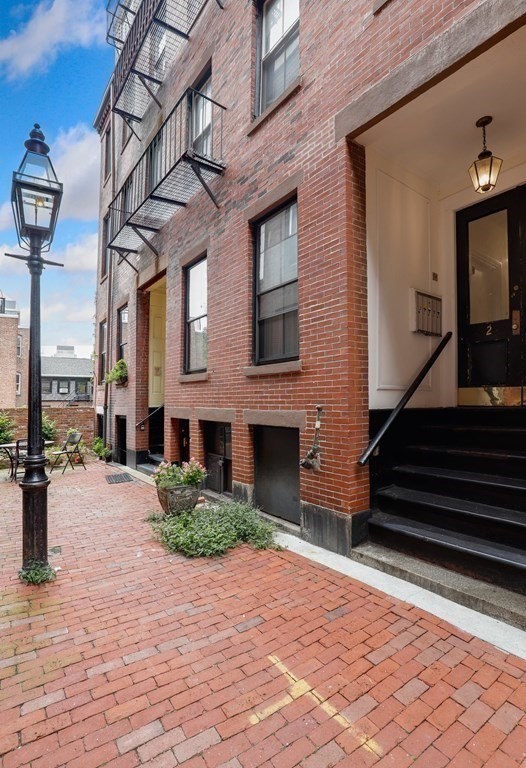 2 Goodwin Place, Unit 3 Boston, MA 02114 - Photo 28 of 28 a front view of a building with a garden