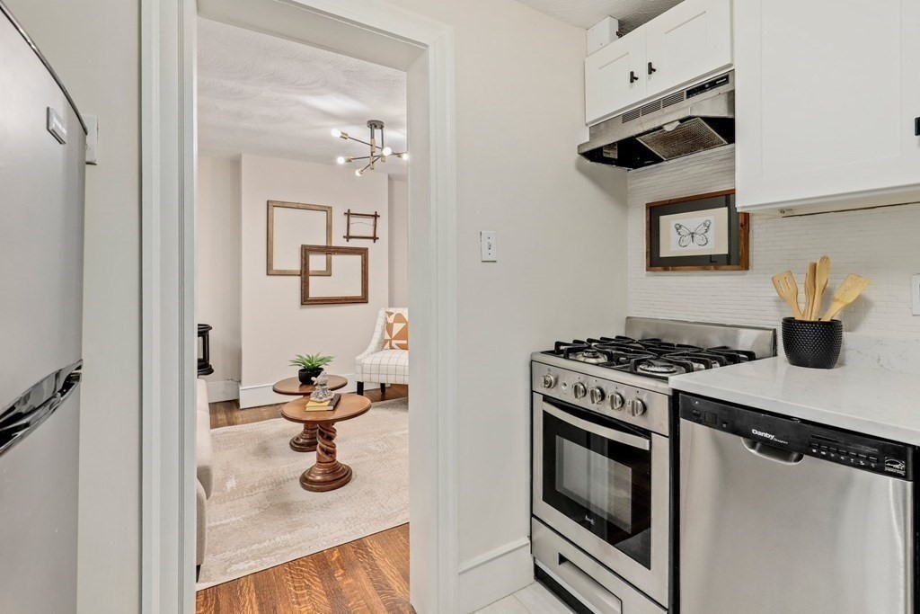 2 Goodwin Place, Unit 3 Boston, MA 02114 - Photo 5 of 28 a kitchen with stainless steel appliances granite countertop a stove and a sink