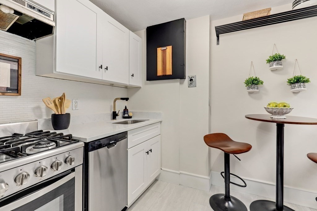 2 Goodwin Place, Unit 3 Boston, MA 02114 - Photo 7 of 28 a kitchen with stainless steel appliances a stove a sink and a cabinets